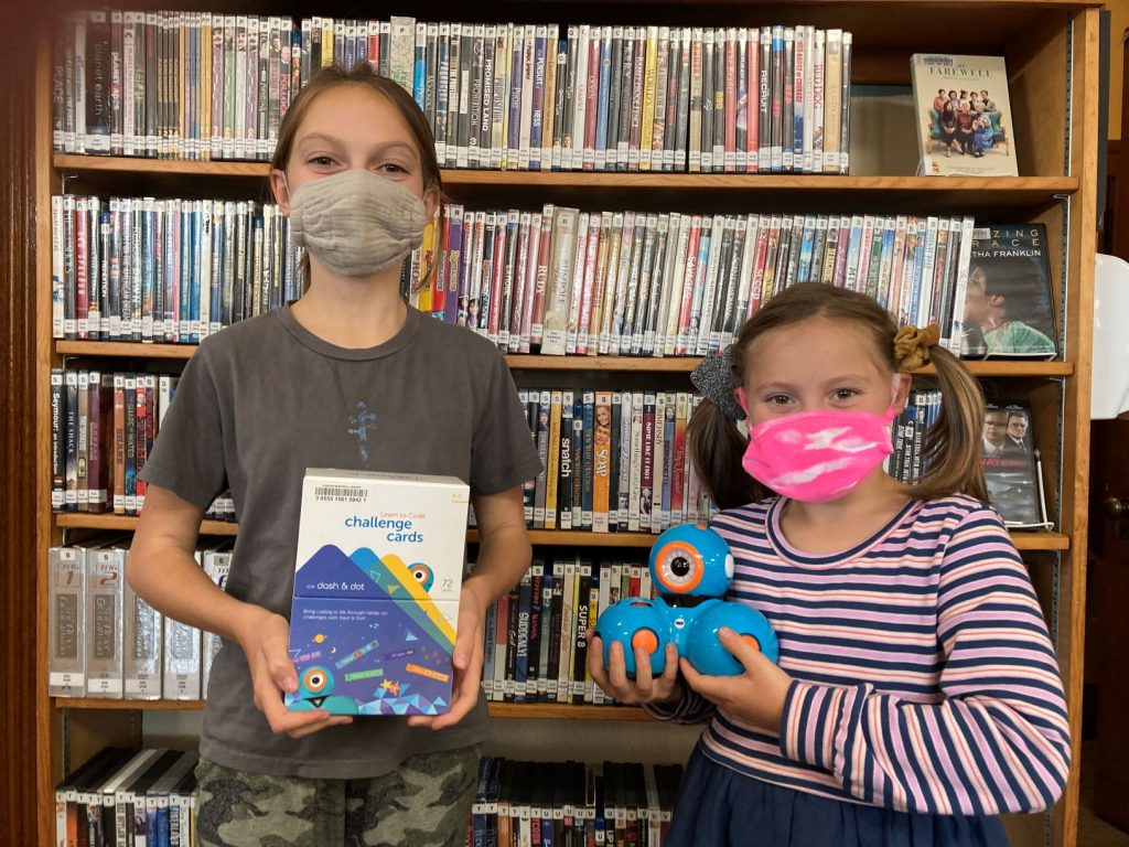 Girls holding coding robots