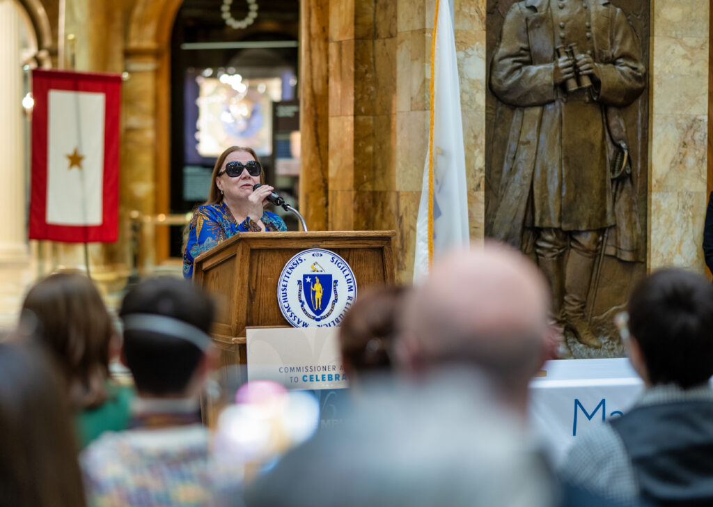 Kim Charlson at the podium speaking to the audience at the MBLC's 135th Anniversary Commissioner Awards.