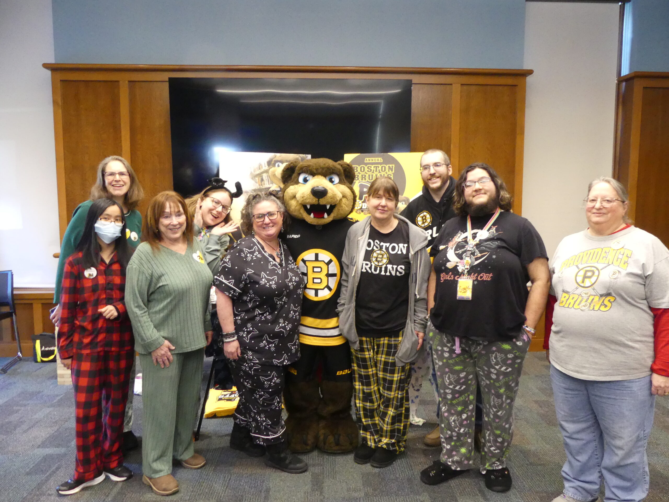 Staff at Swansea Library pose with Bruins Mascot Blades at PJ Drive Event
