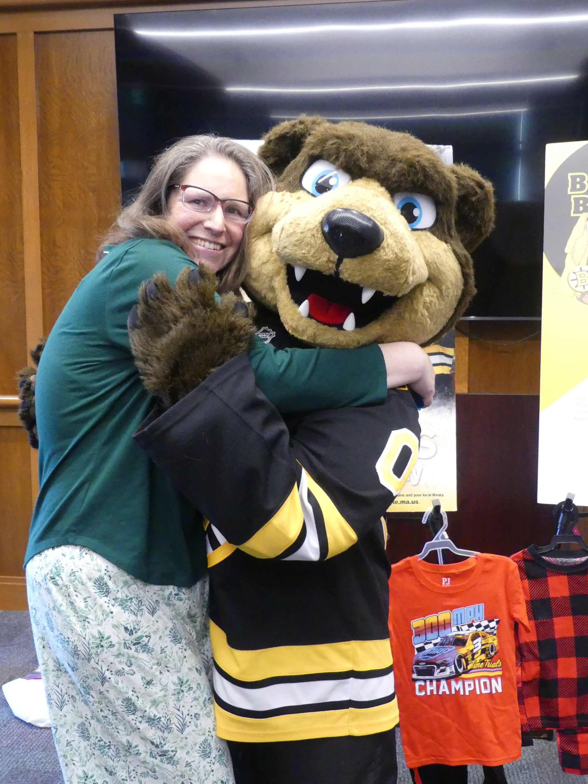 Swansea Free Library Director hugs Bruins Mascot Blades